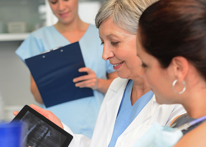 Endodontist Analysing a Patient's Mouth X-ray Endodontist Analysing a Patient's Mouth X-ray - Australian Dental Specialists
